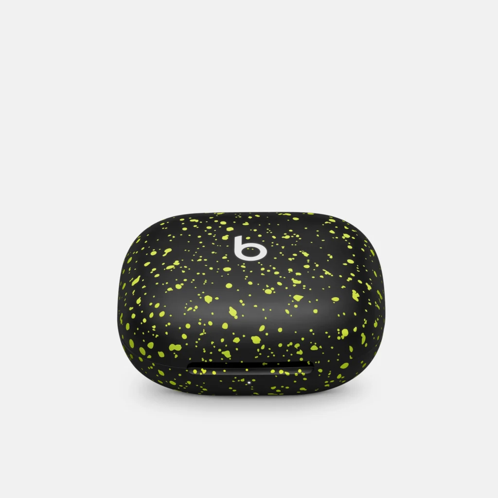 Black wireless earbud case with neon green speckles and a white 