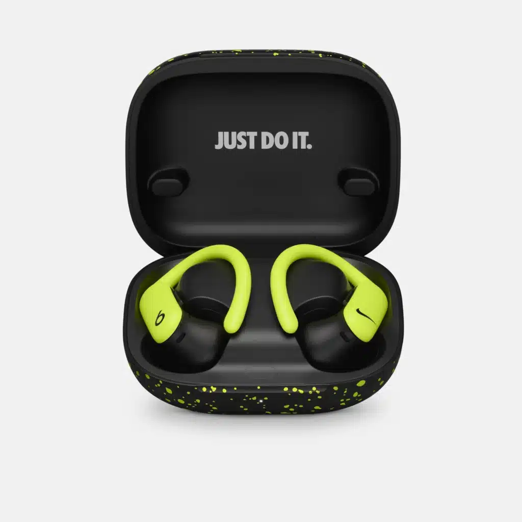 Open black case with neon green Powerbeats Pro 2 earbuds inside, featuring 