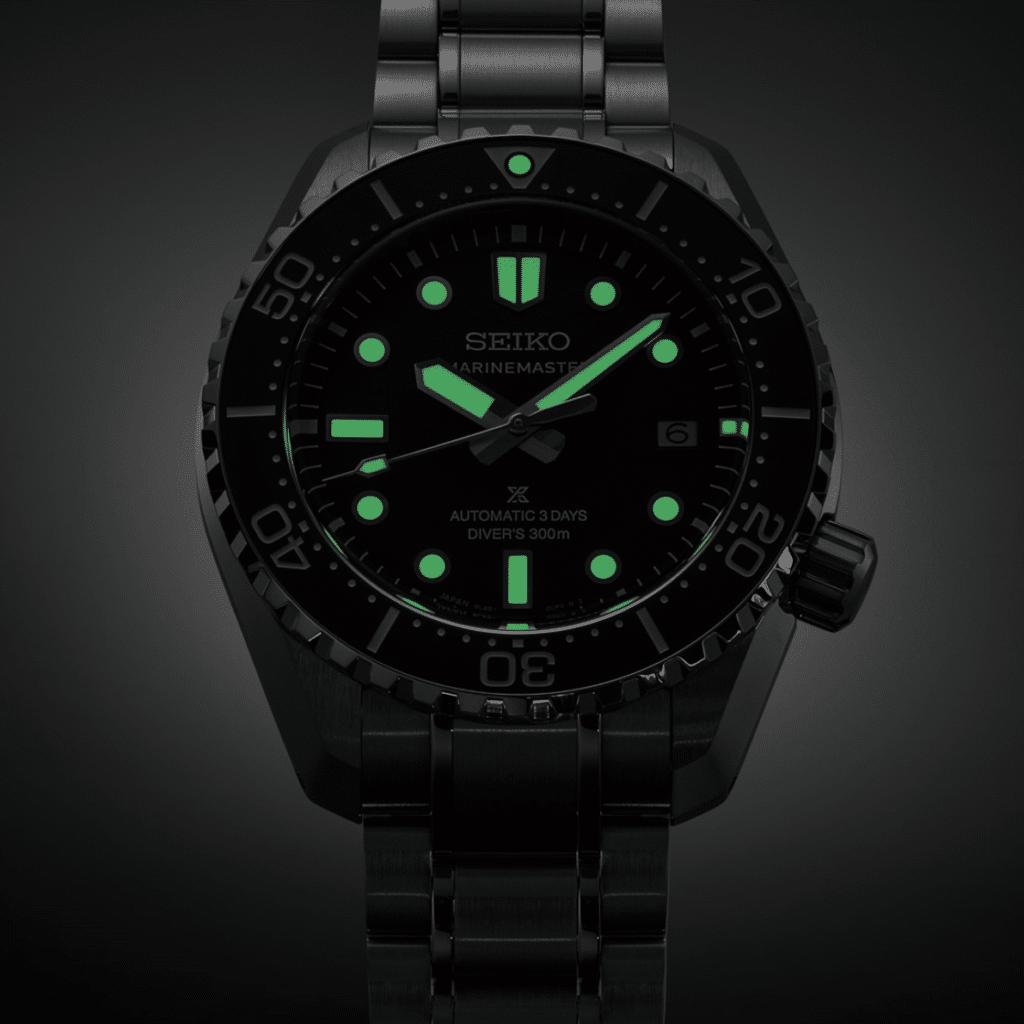 A Seiko Prospex Marinemaster watch with luminescent hands and markers on a dark stainless steel bracelet.