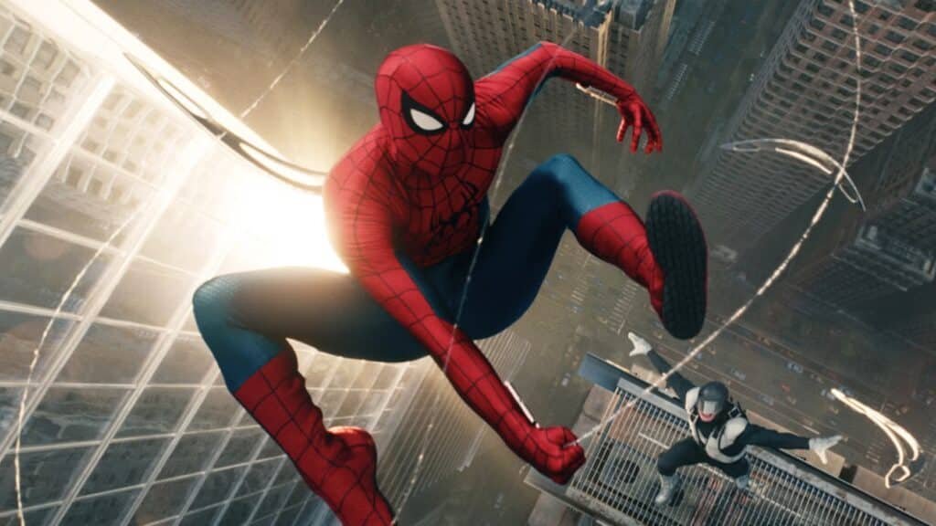 Spider-Man swings through a city skyline, with another suited figure in the background on a building.
