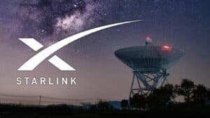 A large satellite dish under a starry night sky with the Starlink logo prominently displayed.