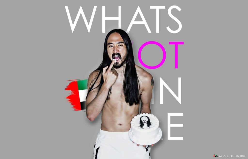 Shirtless man with long hair holds a cake, standing in front of text saying "WHAT'S HOT IN" and a UAE flag graphic.