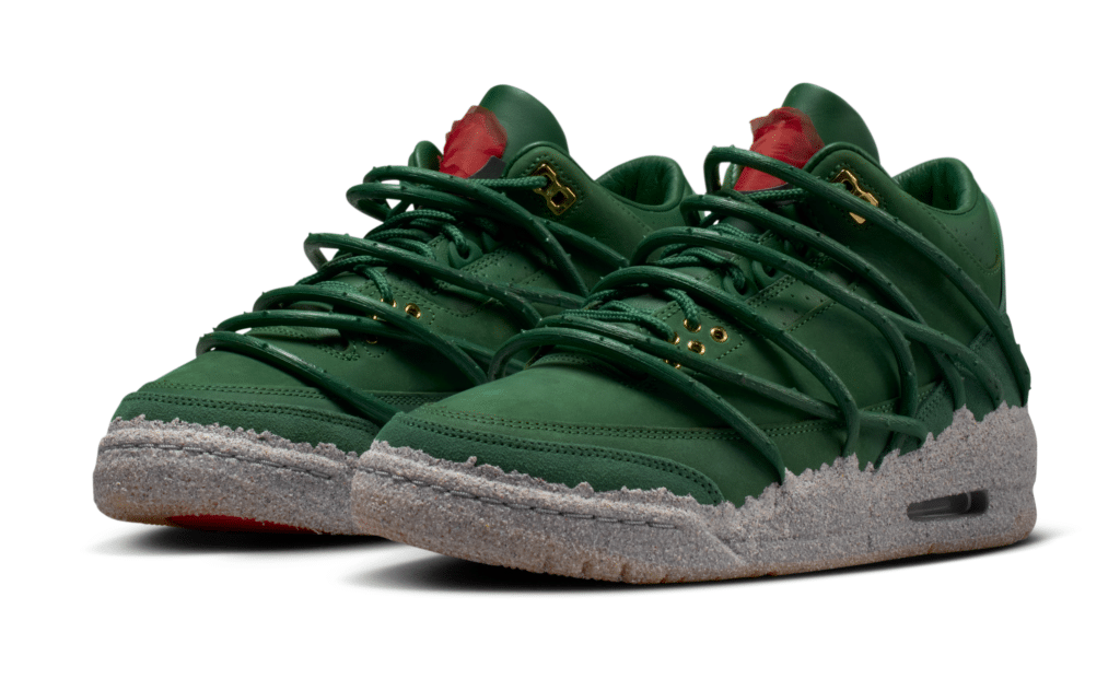 Green Teyana Taylor x Air Jordan 3 sneakers with intricate lacing and speckled gray soles, featuring a red accent on the tongue.