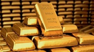 A stack of gold bars with one prominently labeled "FINE GOLD 999.9 1000g" on top.