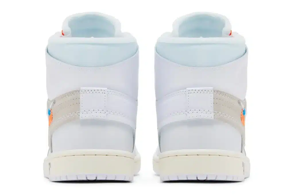 The back view of a pair of high-top sneakers with white soles and light-colored straps.