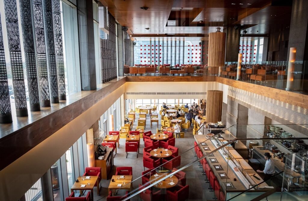 Zuma Dubai dining room in DIFC, with red chairs and a mezzanine level