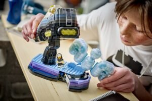 A person is playing with a space-themed LEGO set featuring a small astronaut and a large spacecraft.
