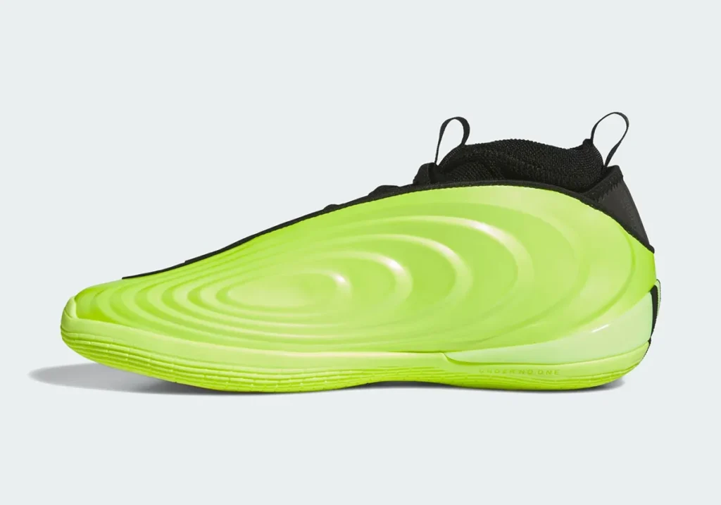 A vibrant neon green sneaker with a textured, wavy side pattern and black upper.