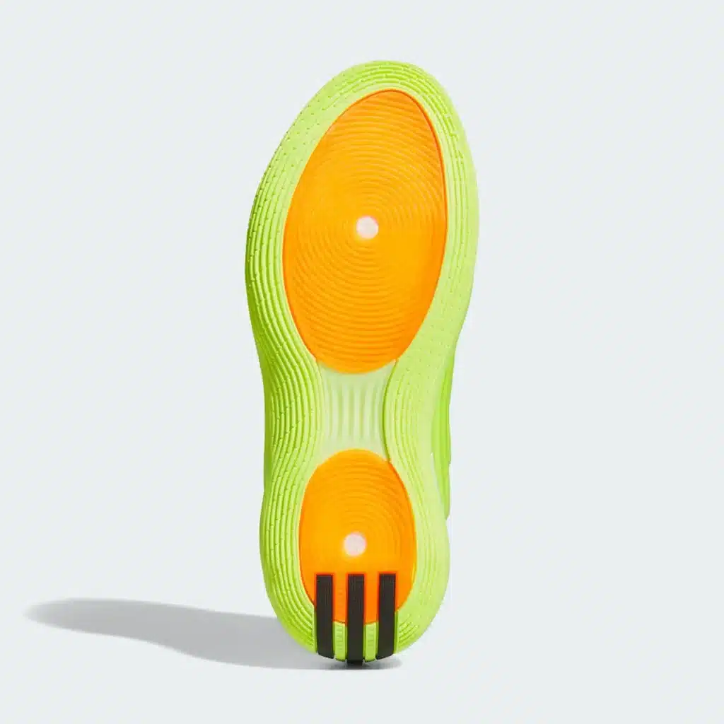 A bright Adidas Harden Vol. 10 “Hi-Res Yellow” sole with orange circular patterns and black stripes on the heel against a light background.
