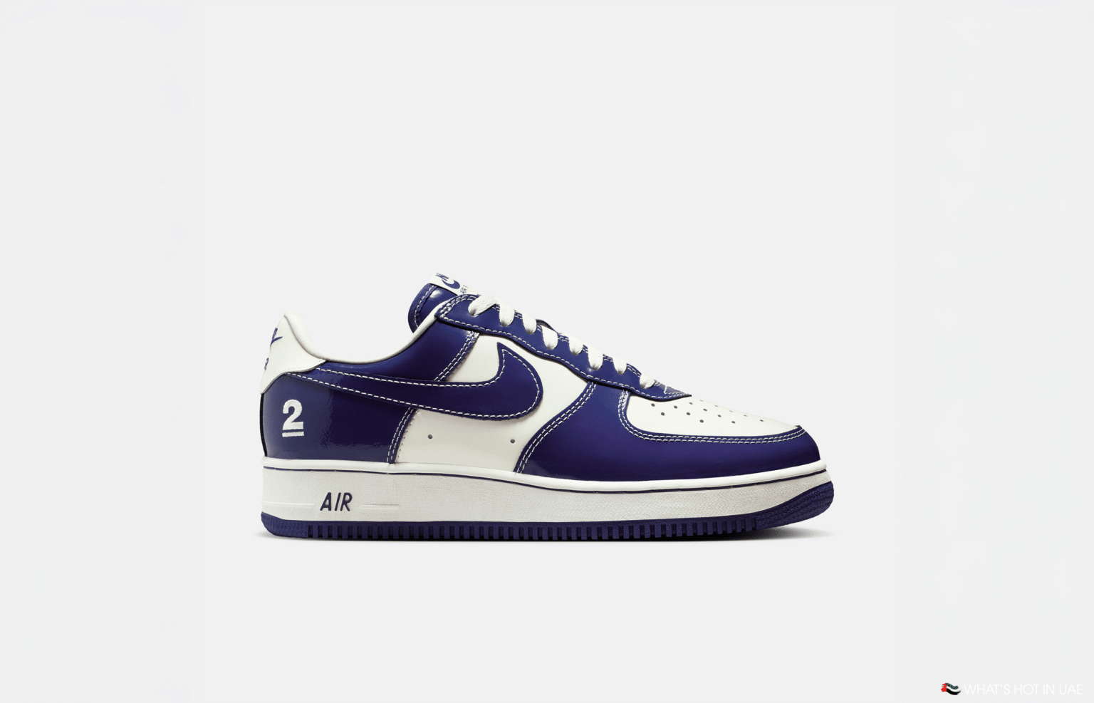 A white and purple sneaker with the number 2 on the heel and "AIR" on the midsole.