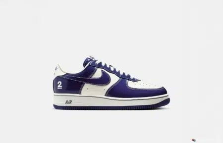 A white and purple sneaker with the number 2 on the heel and "AIR" on the midsole.