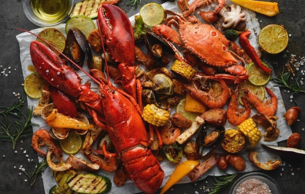Best Seafood Restaurants on Abu Dhabi Corniche: A seafood boil featuring lobster, crabs, shrimp, corn, potatoes, and grilled vegetables, arranged on a parchment surface.