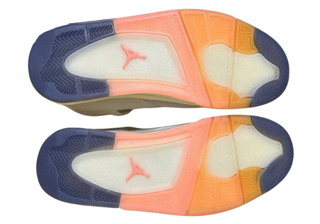 The soles of sneakers featuring a gradient design of blue, pink, and orange with a red logo at the center.