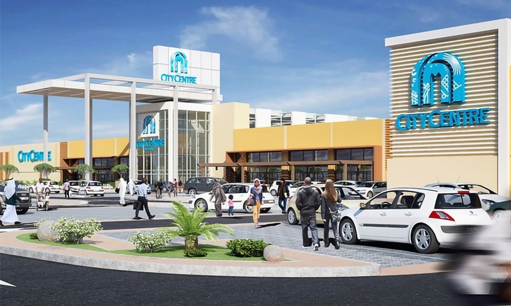 Exterior rendering of a CityCentre shopping mall with parked cars and people in front of the entrance