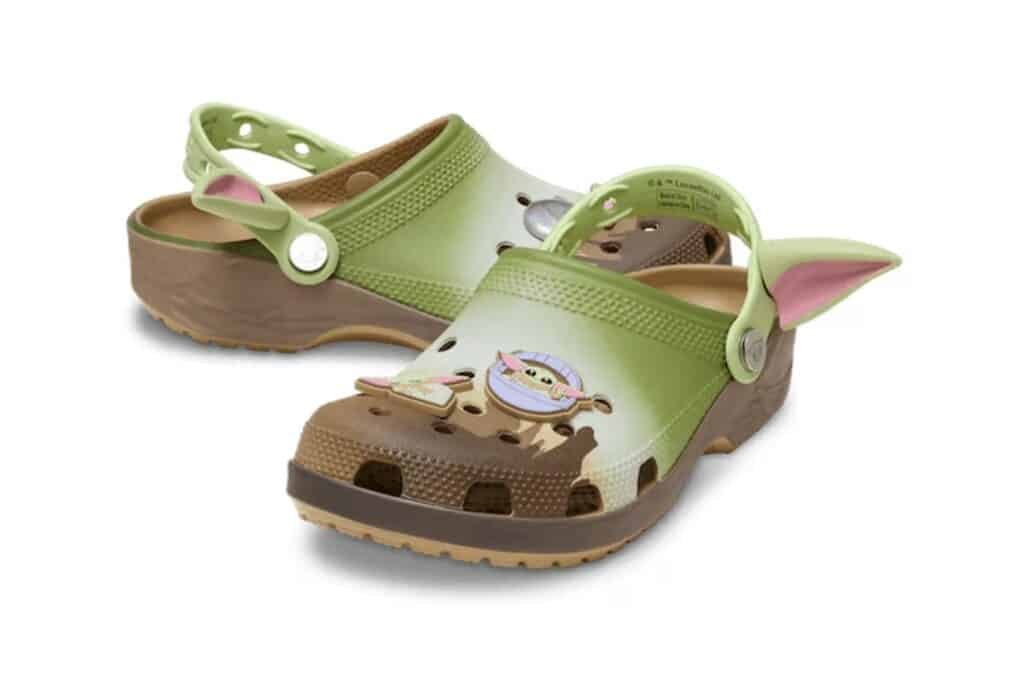 Pair of green and brown Star Wars Crocs with Yoda-themed decorations and ear accents.