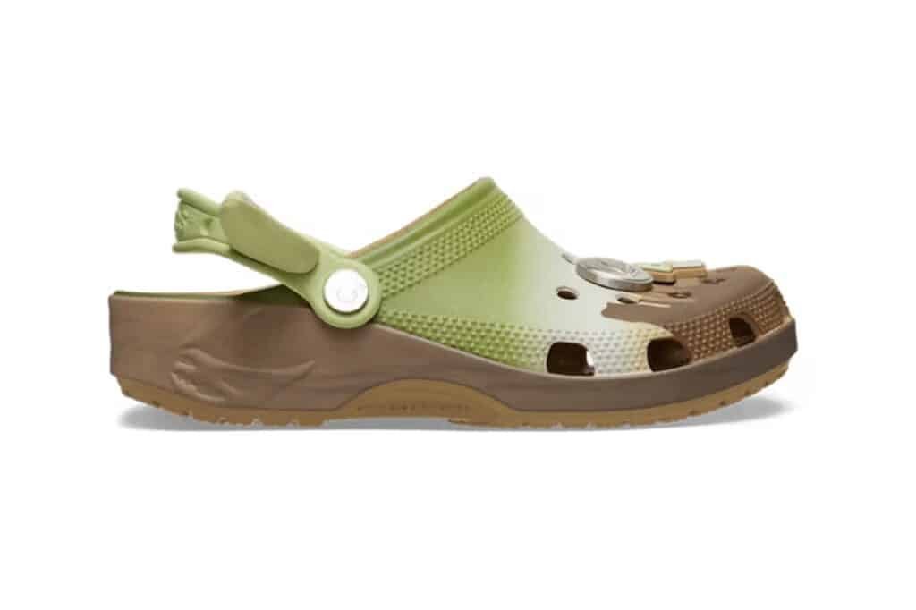 A two-toned slip-on clog with a green upper and brown sole, featuring ventilation holes and a heel strap.