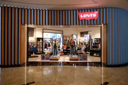 Storefront of a Levi's clothing store with mannequins in denim outfits displayed at the entrance.