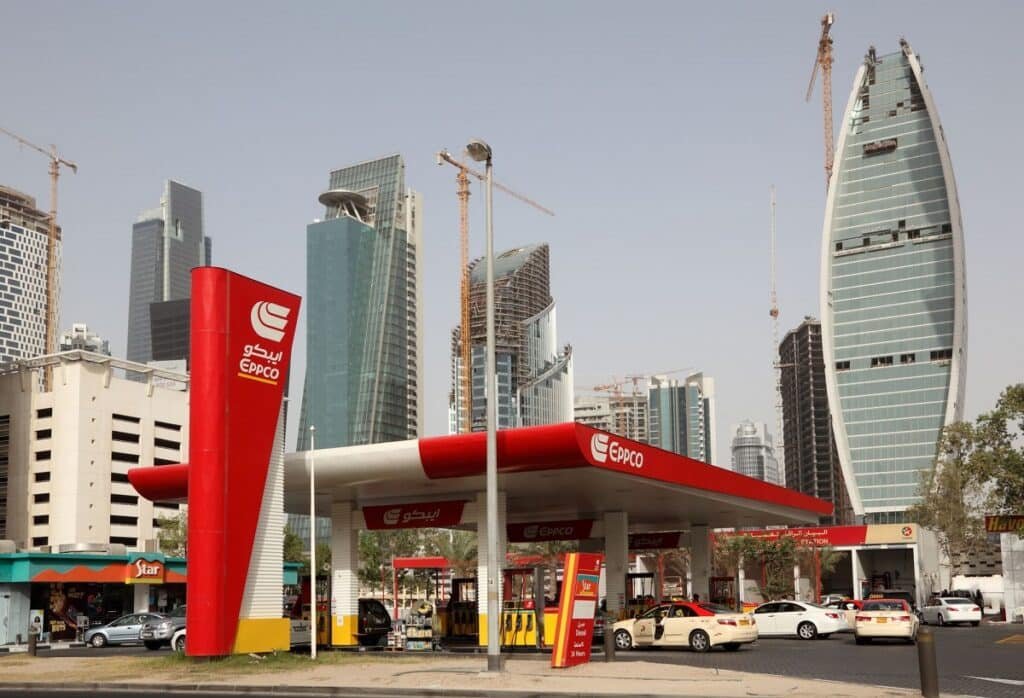 UAE Petrol Prices May 2026: A modern gas station in a city with tall skyscrapers and construction cranes in the background.