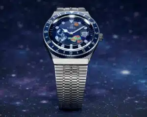 A wristwatch with a silver metal band and a blue dial featuring colorful Space Jam themed graphics and a basketball hoop.