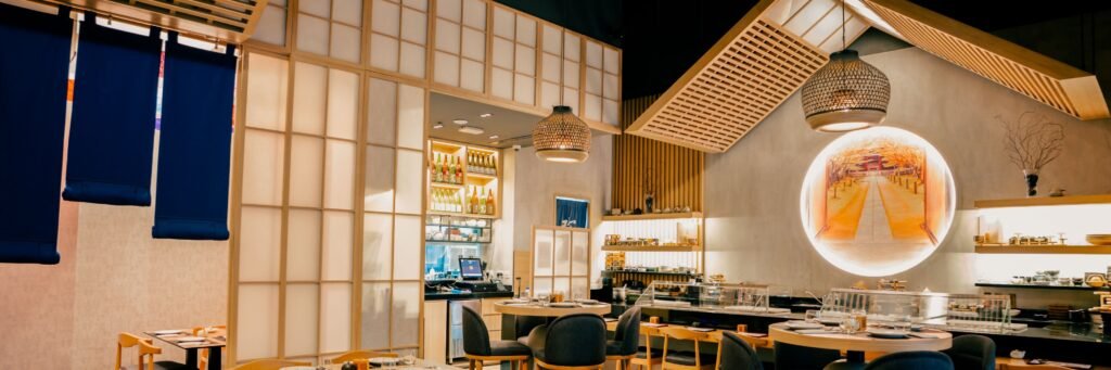 Modern Japanese restaurant interior with shoji screens, hanging lamps, and neatly set tables