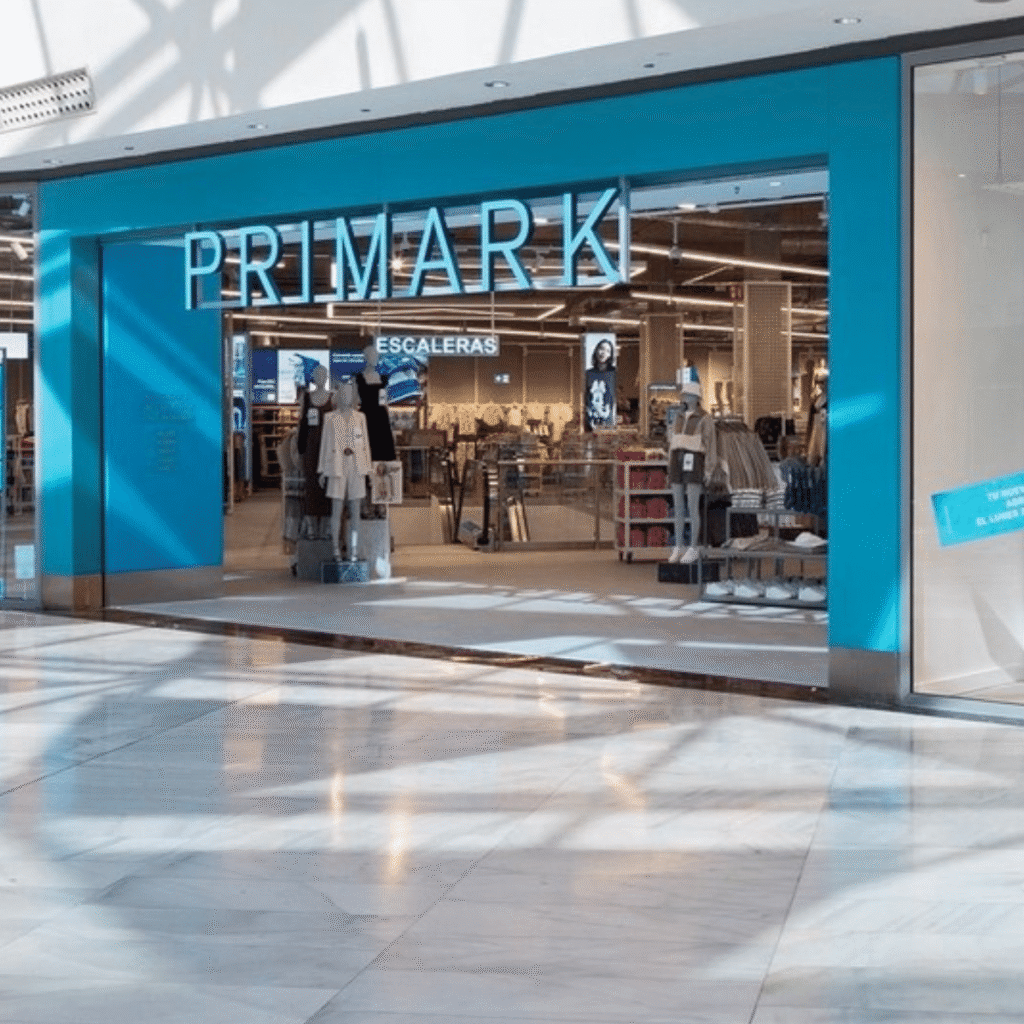 PRIMARK store entrance with bright blue signage and clothing displays inside a shopping mall