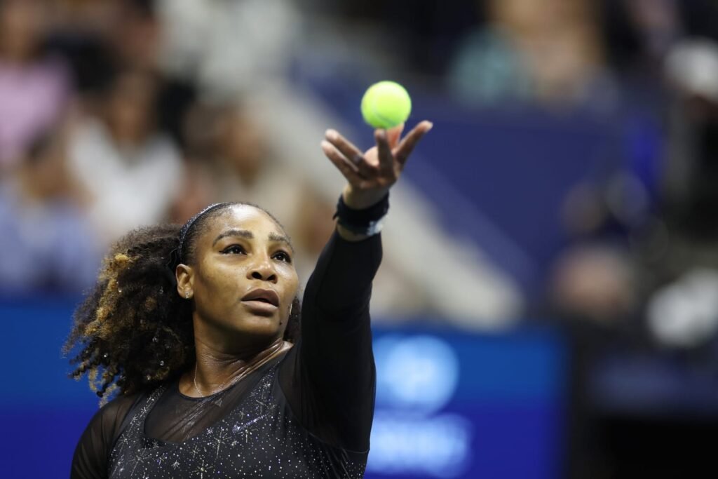 Tennis player Serena Williams tosses a ball for a serve on court
