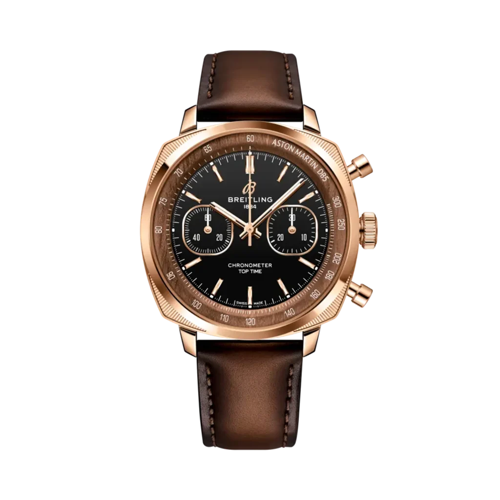 Breitling and Aston Martin DB5 chronograph wristwatch with a black dial, rose gold case, and brown leather strap on a black background