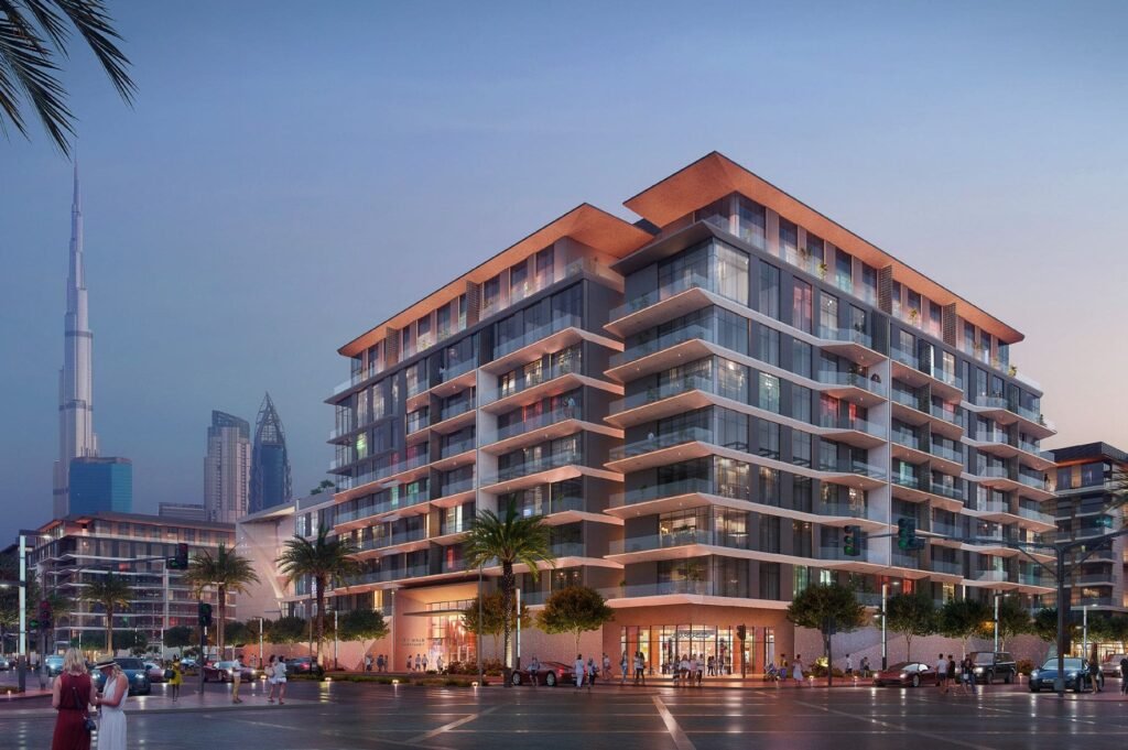 Modern glass apartment building at dusk with Dubai City Walk skyline and Burj Khalifa in the background