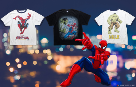 Three graphic T-shirts featuring Spider-Man and Hulk, with a larger Spider-Man illustration on a blurred city-light background