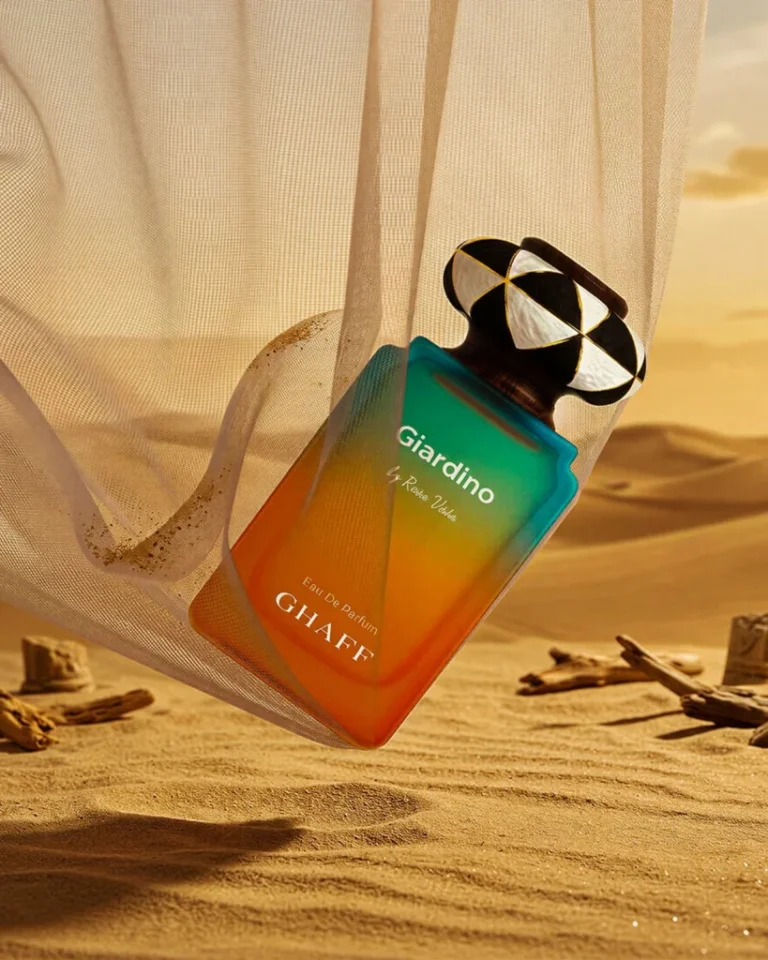 GHAFF perfume bottle staged on sand against a desert sunset