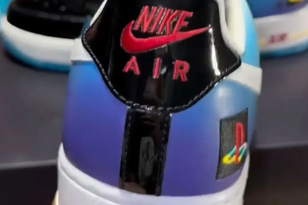 Close-up of a Nike Air sneaker tongue with black and purple-blue color blocking and red logo accents