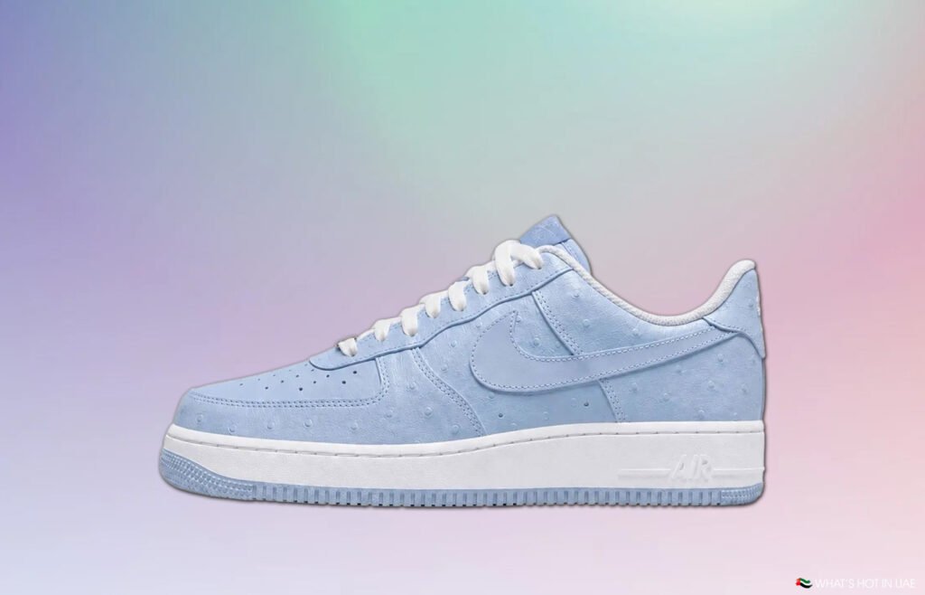 Light blue Nike Air Force 1 sneaker on a pastel gradient background