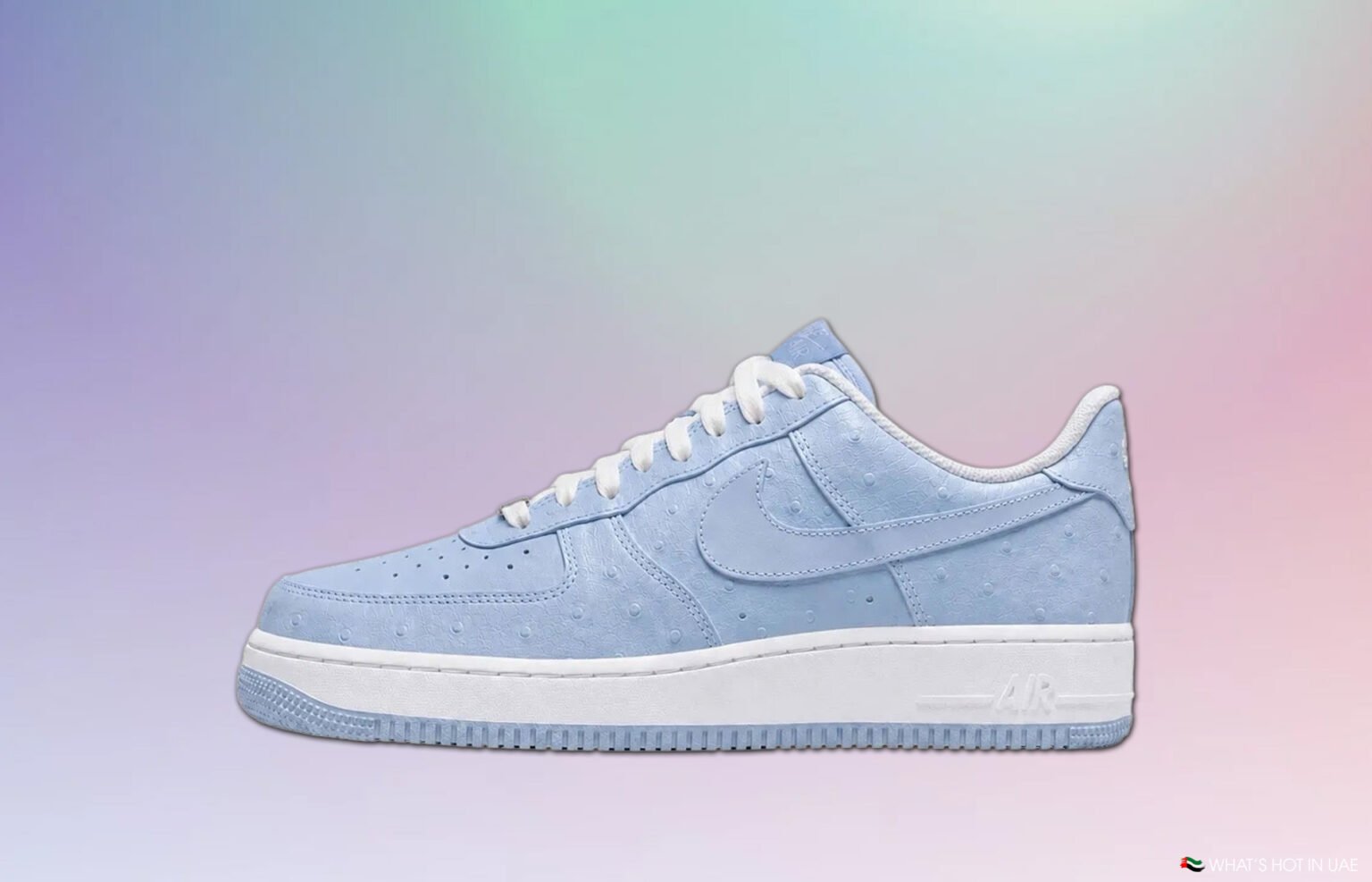 Light blue Nike Air Force 1 sneaker on a pastel gradient background