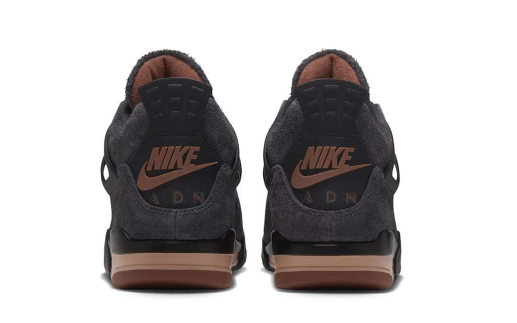 Pair of dark gray Nike air jordan 4 'london' sneakers shown from the rear, with brown accents and visible Air branding