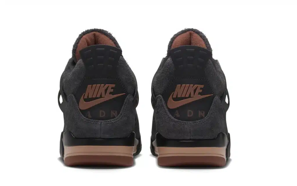 Pair of dark gray Nike air jordan 4 'london' sneakers shown from the rear, with brown accents and visible Air branding
