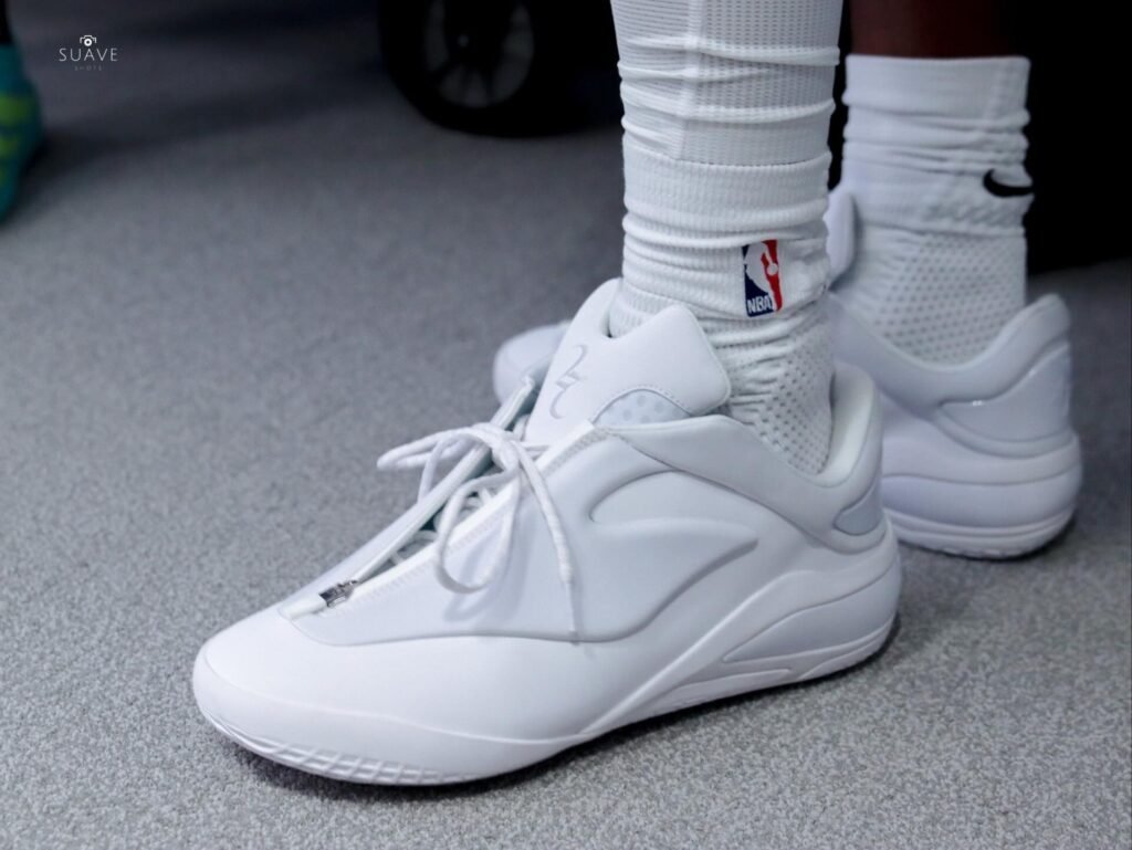 White high-top converse shai 001 ghosted sneakers with laces, worn with white NBA-logo socks