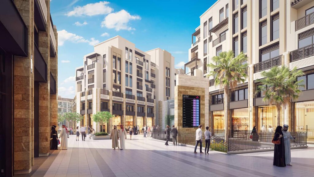 Sunny outdoor Deira Gold Souk  between modern apartment buildings with palm trees and people walking and shopping