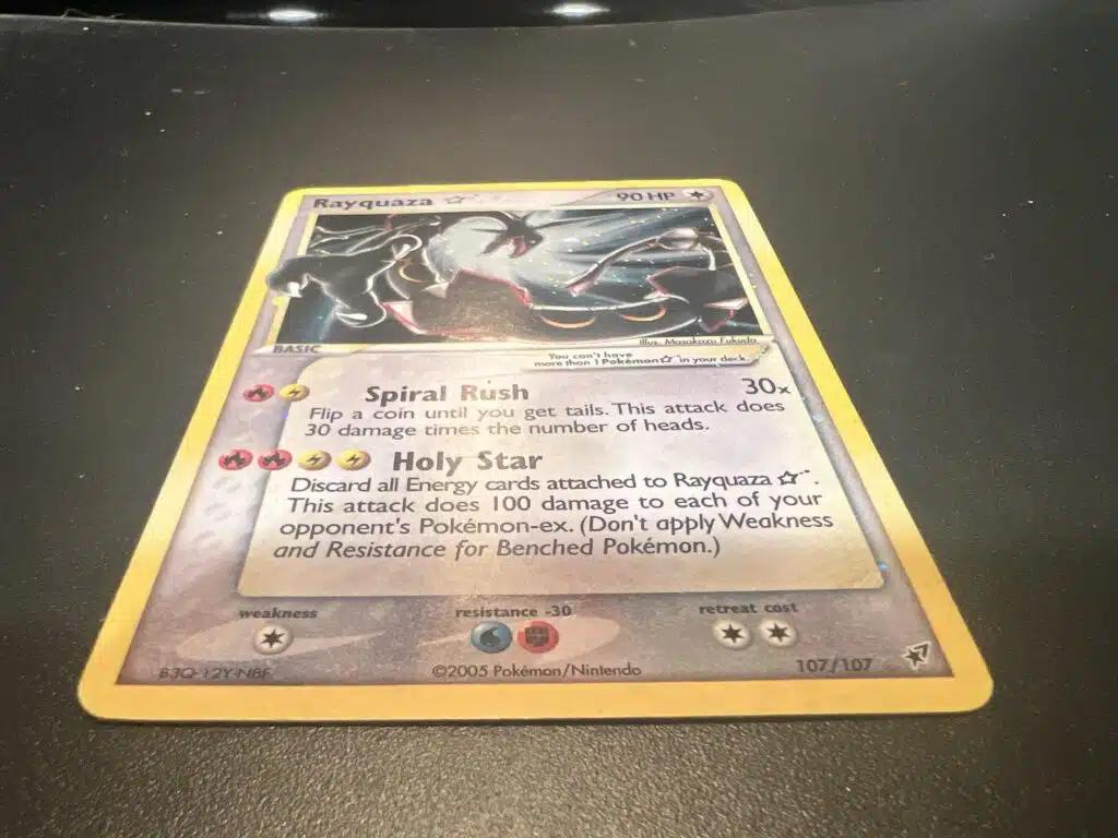 A Pokémon trading card featuring Rayquaza, with 90 HP and the attacks Spiral Rush and Holy Star