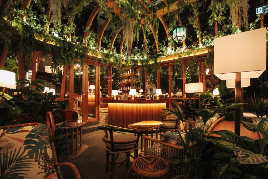 The Guild in DIFC, Dubai, with wood arches, hanging plants and a lit bar