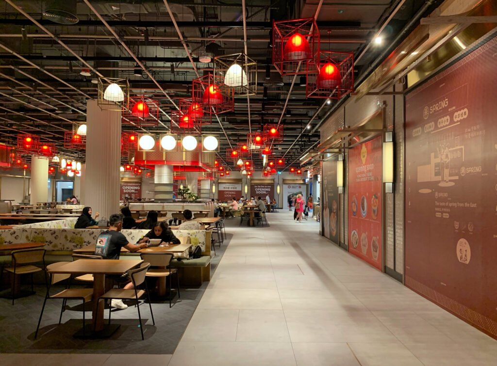 Food court at The Dubai Mall, with red cage pendant lights and a wide walkway