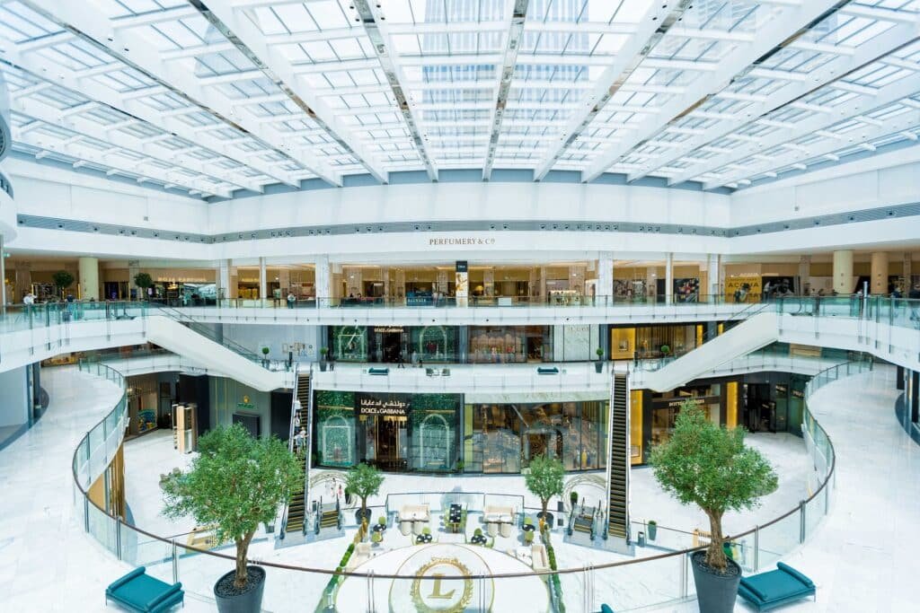 Bright, multi-level Fashion Avenue at The Dubai Mall atrium with skylights, escalators, and designer boutiques