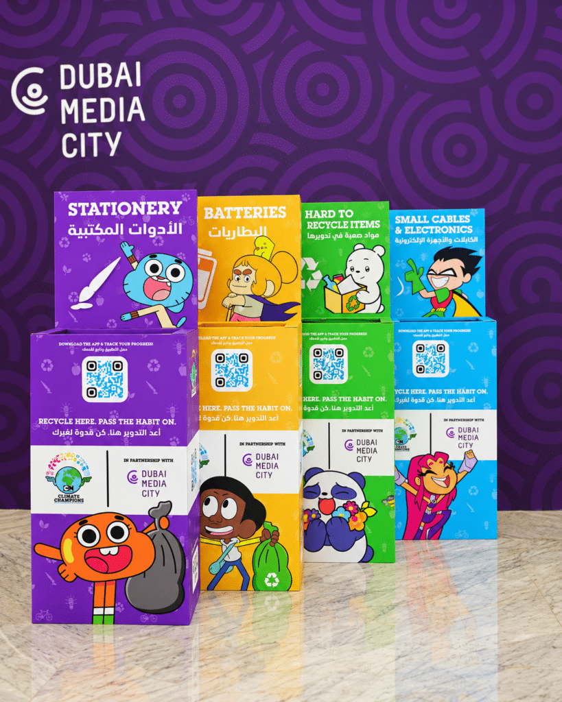 Colorful recycling collection boxes for stationery, batteries, hard-to-recycle items, and electronics, branded Dubai Media City