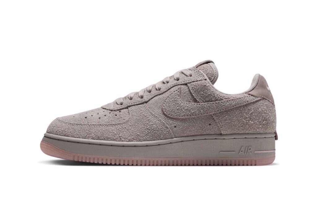 Gray Nike low-top sneaker with a Subway Rat textured suede upper, side swoosh, and pinkish sole