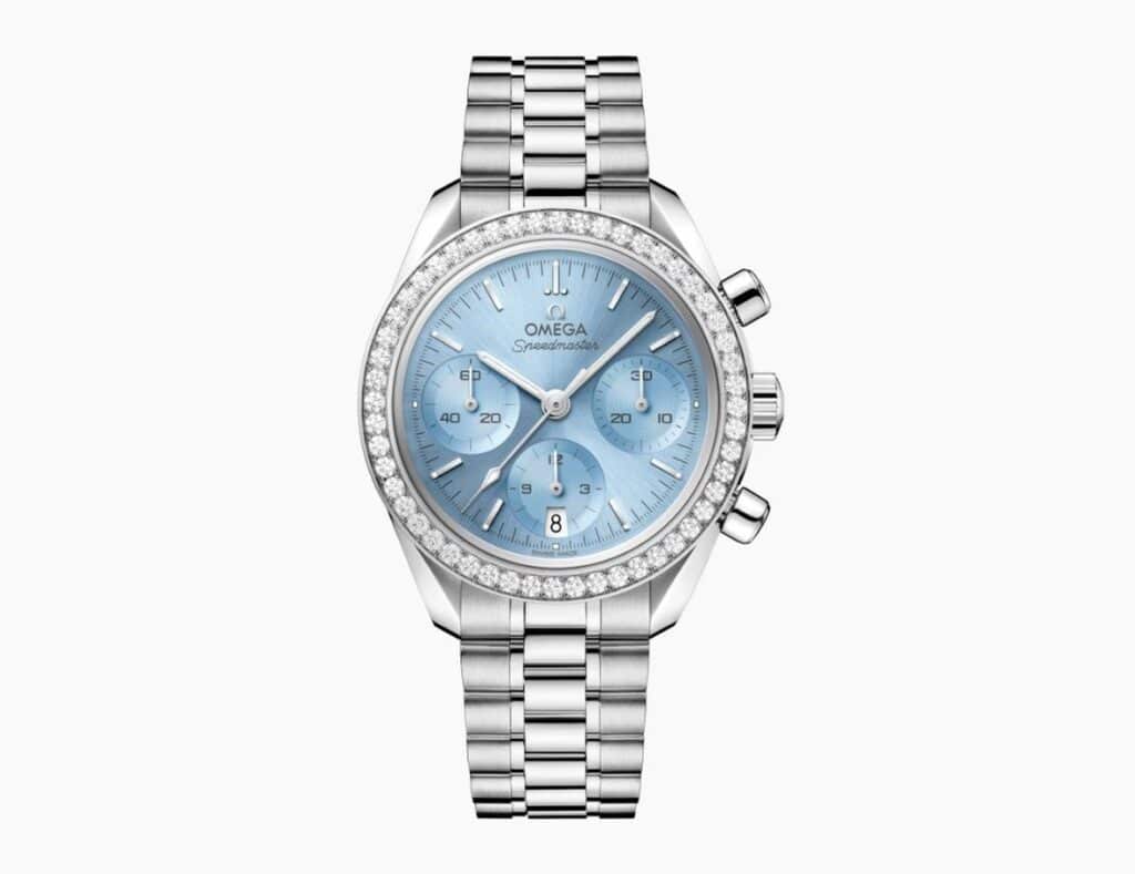 Omega Speedmaster chronograph with a light blue dial, diamond-set bezel, and stainless steel bracelet