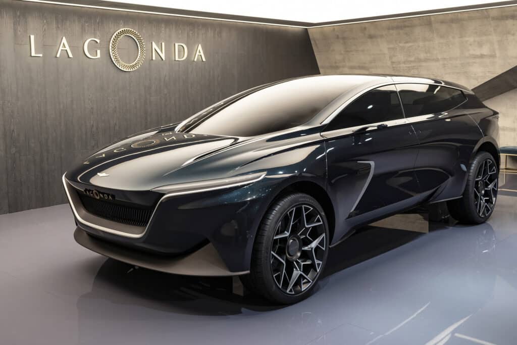 A dark blue Aston Martin EV concept car displayed in a showroom