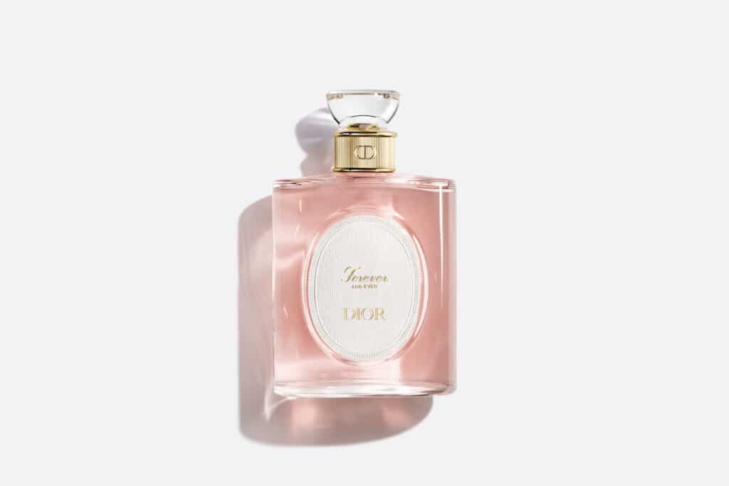 Dior Forever and Ever perfume in a pink glass bottle with a gold cap