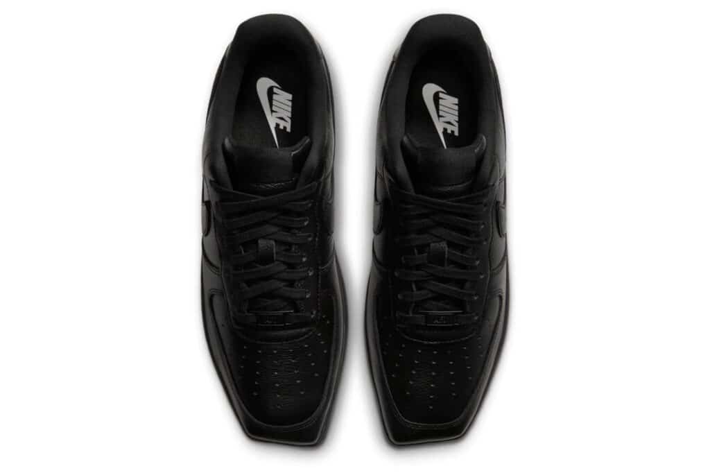 Pair of black Nike sneakers viewed from above, with laces and perforated toe boxes