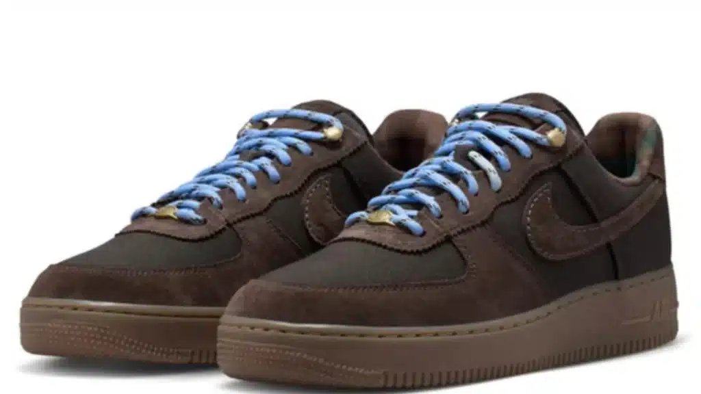 Pair of brown low-top sneakers with blue laces and swoosh logos